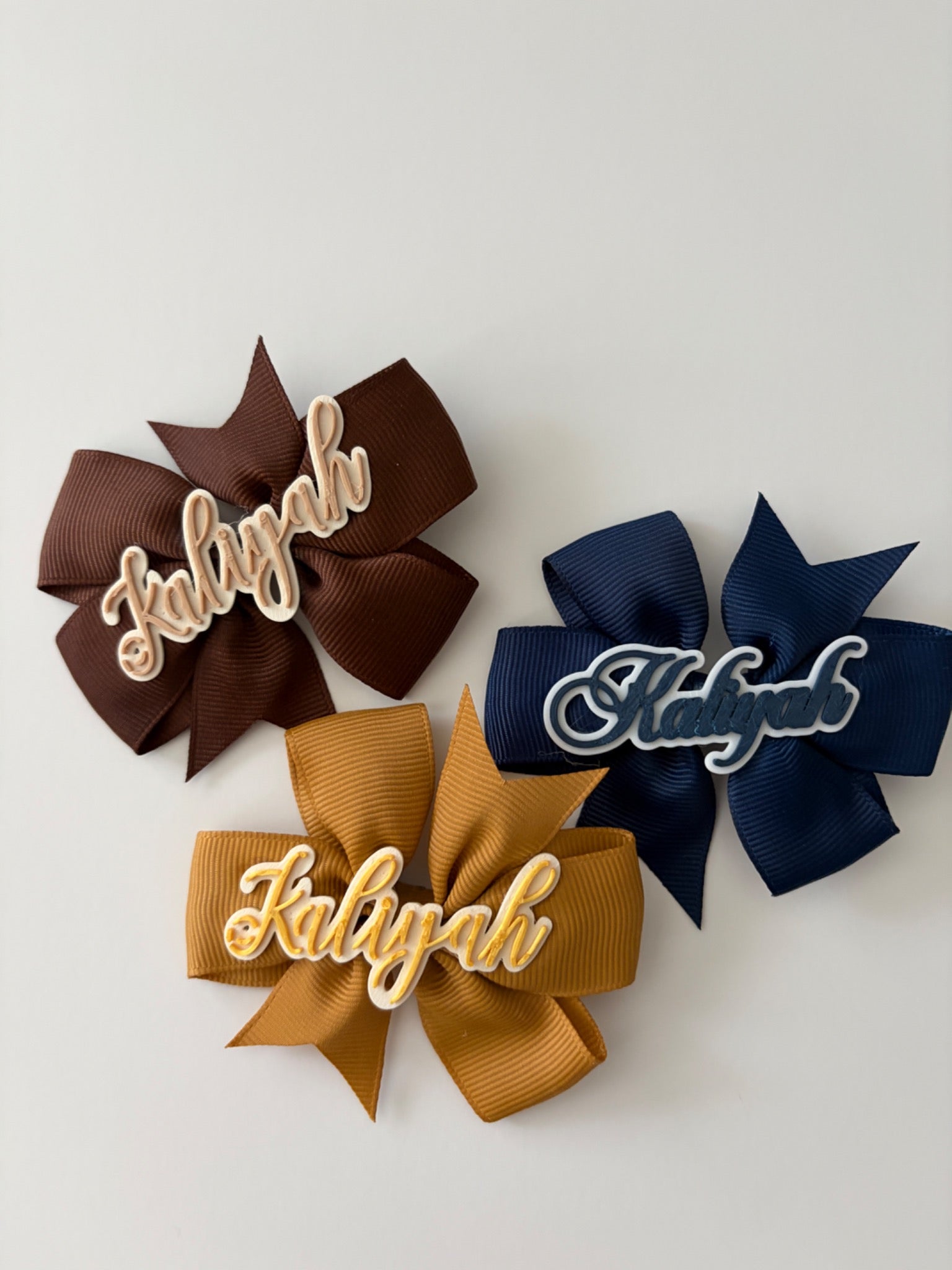 Personalized Kaliyah hair bows in brown, mustard and navy