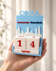Custom Skyline Perpetual Desk Calendar, held in hand for scale