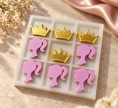 White tray tic-tac-toe set with pink girl silhouette pieces and gold crown pieces